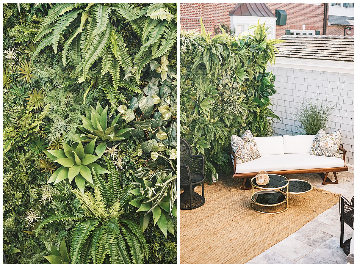 A midcentury-inspired seating area set up in front of a tropical grass wall.