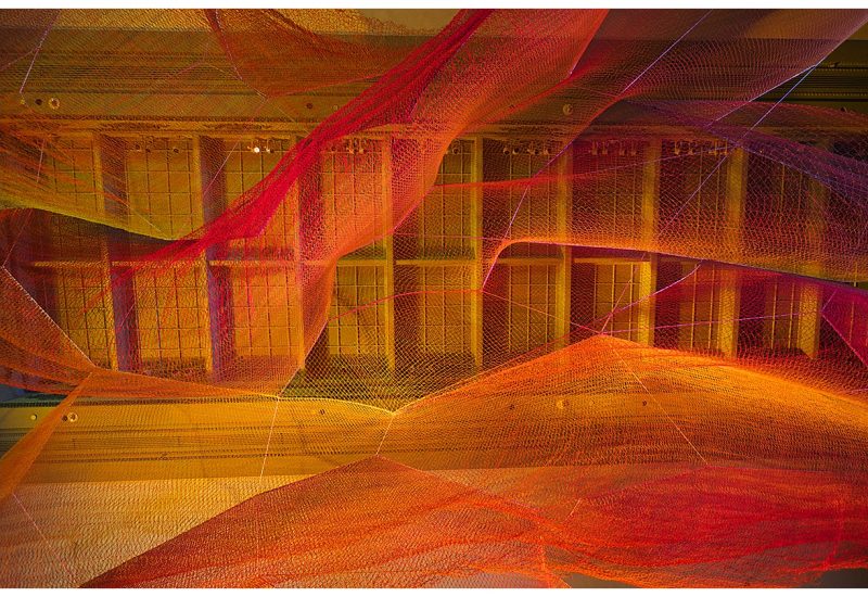 Vibrant fiber and lighting installation at the Renwick Gallery, creating a mesmerizing and artistic ambiance for a wedding ceremony. Rentals by Something Vintage Rentals, the U.S. East Coast’s best event rental and wedding decor company.