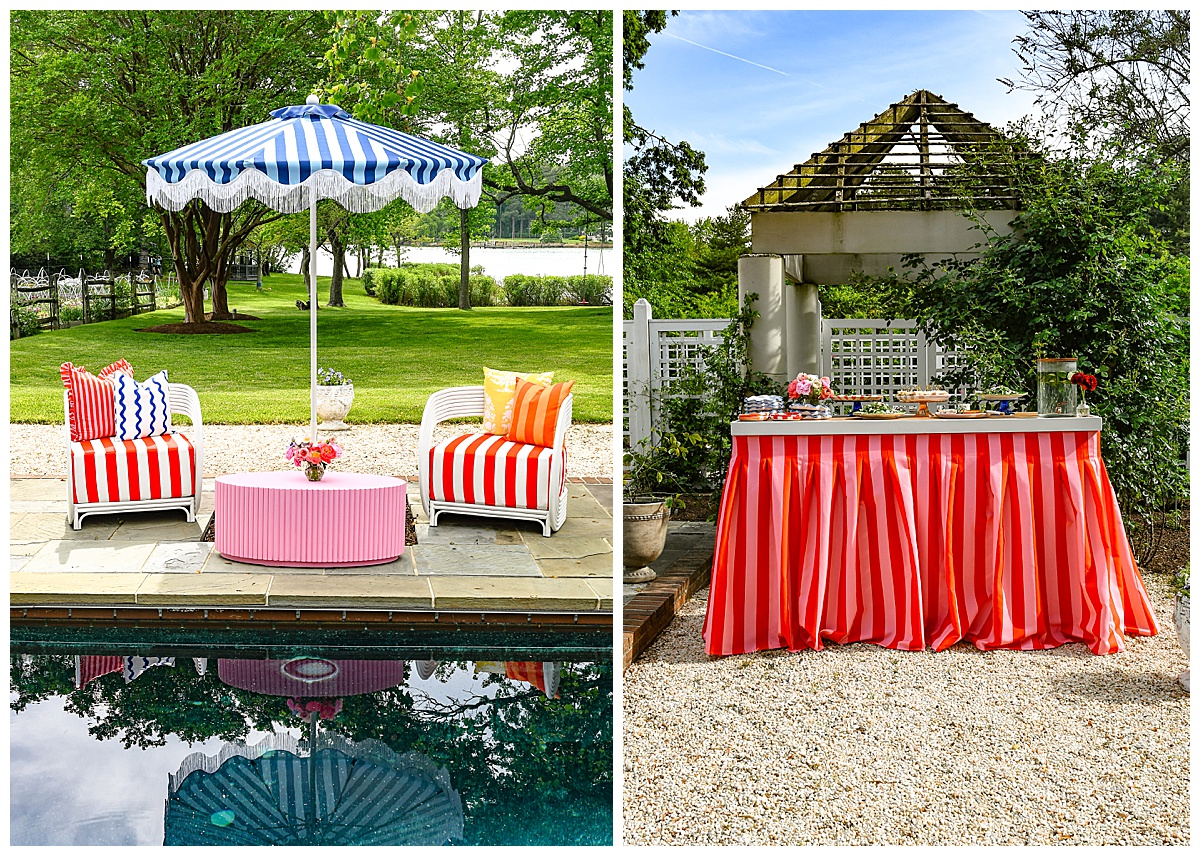 Poolside lounge with red striped chairs, a pink coffee table, and a blue fringe umbrella, paired with a red and pink striped pleated fabric bar under a garden pergola. Rentals by Something Vintage Rentals, the U.S. East Coast’s best event rental and wedding decor company.