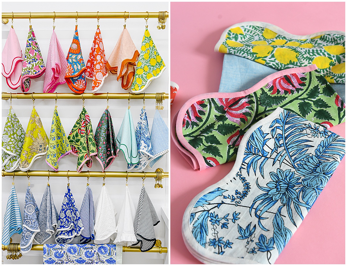 Assorted printed linens in bold floral and striped patterns, styled on brass racks and pink backdrops to highlight the OG linen collection from Something Vintage Rentals, the U.S. East Coast’s best event rental and wedding decor company.