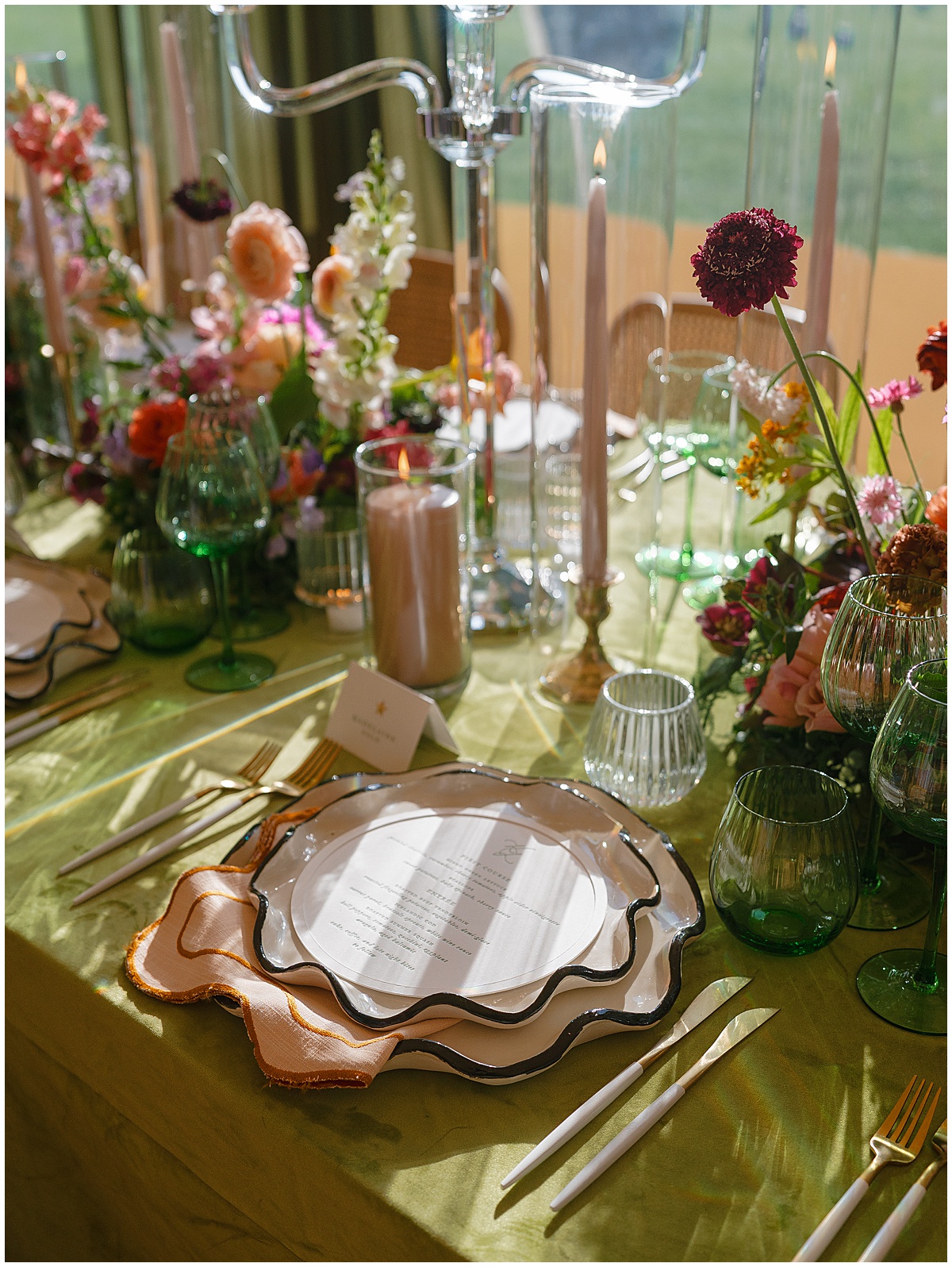 Chartreuse satin linen tablescape with scalloped charger plates, peach napkin, green stemware, and vibrant mixed florals for 2026 wedding trends by Something Vintage Rentals